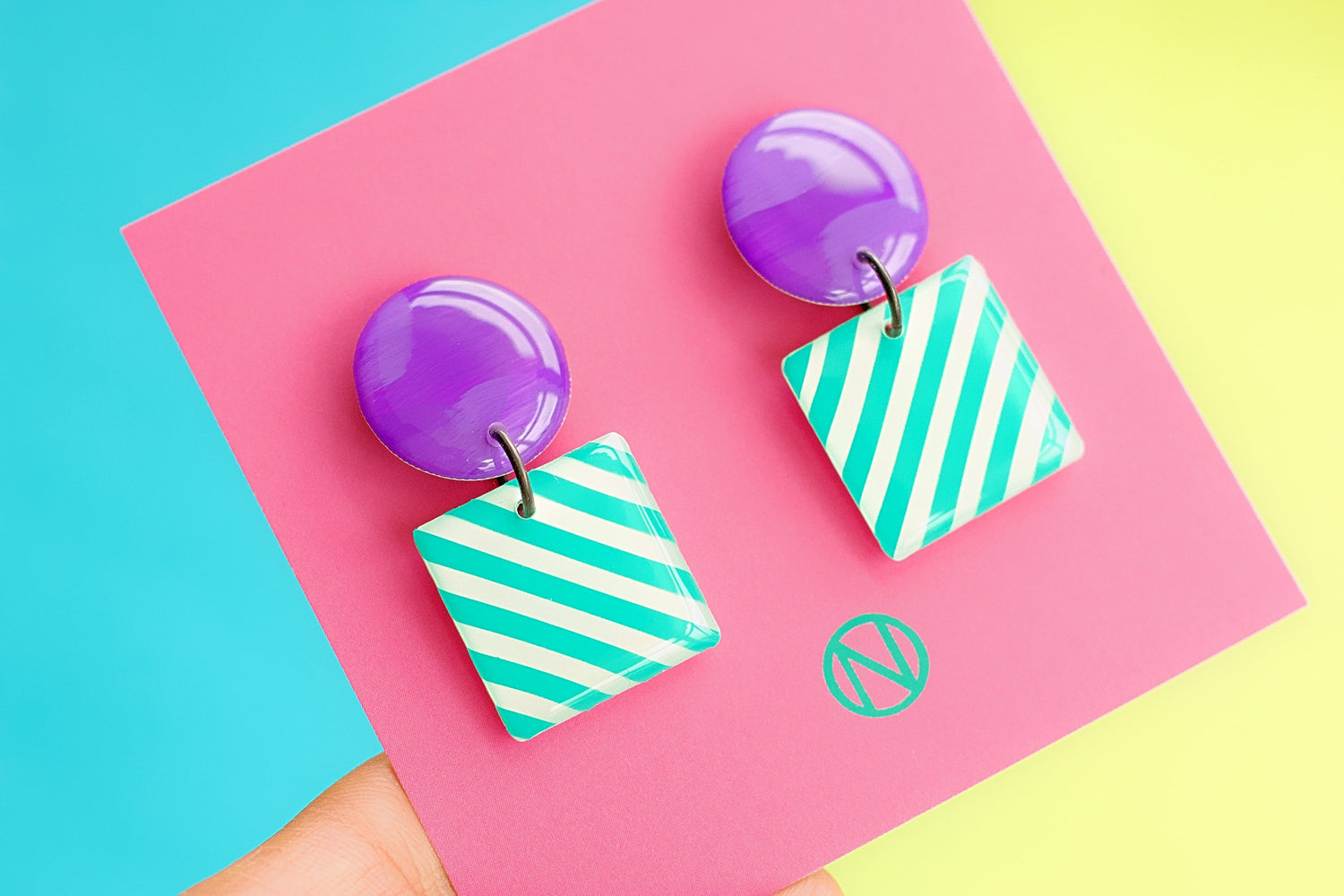 colourful geometric earrings on hoops